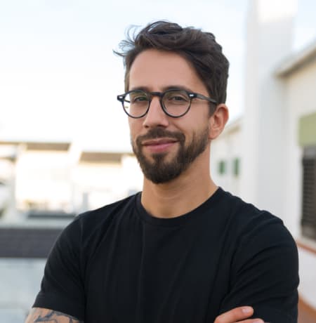 Man in glasses with a beard in a black t-shirt